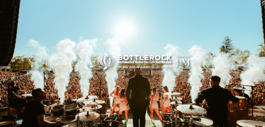 view from behind a live band and dancers on stage at bottlerock music festival